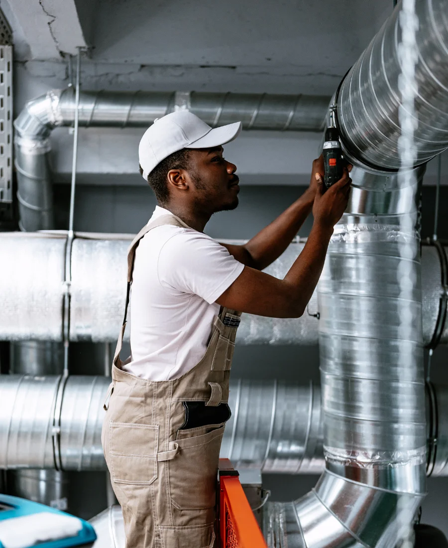 Professional worker repairing ventilation system